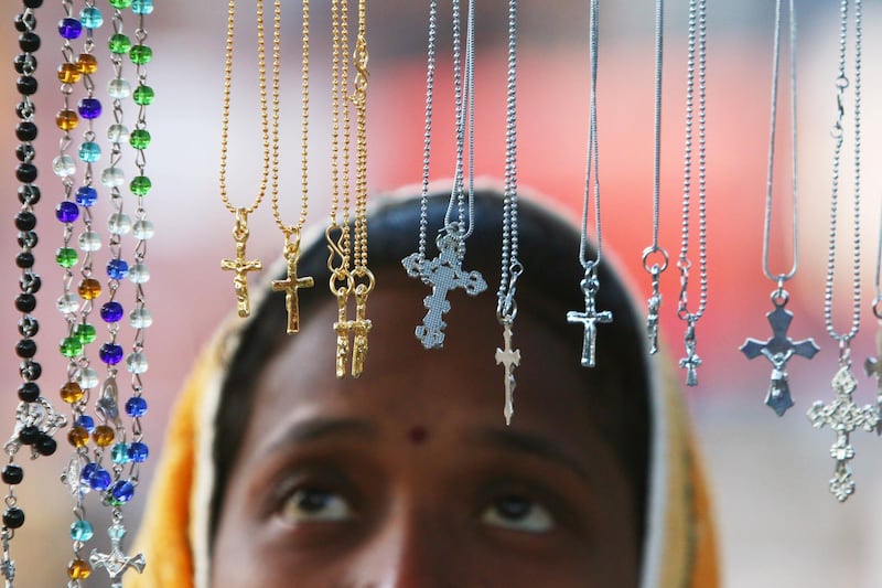A woman looks at religious lockets at a stall outside a church during the Christmas celebrations in Chandigarh, India, on December 25, 2017. Ajay Verma / Reuters