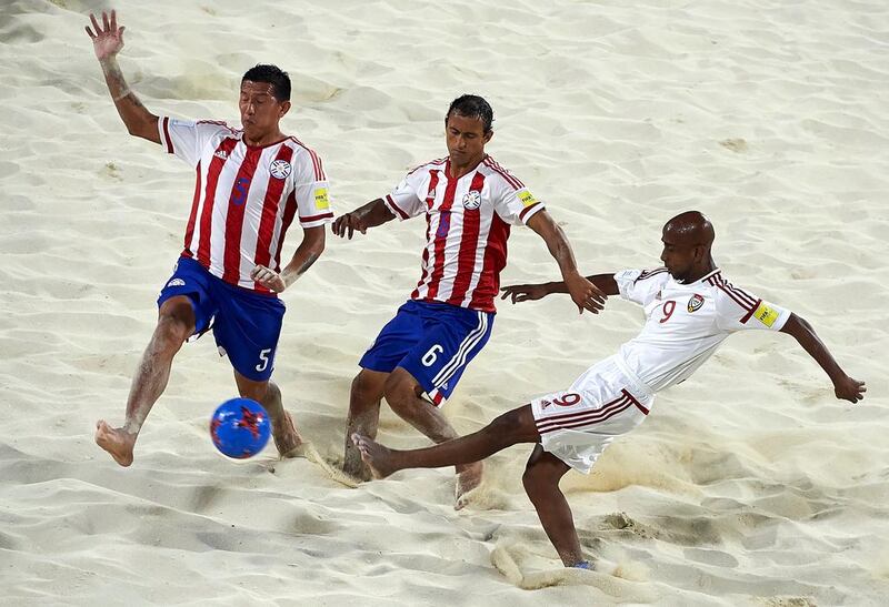 The UAE, in white, defeated Paraguay to boost their chances of reaching the Fifa Beach Soccer World Cup quarter-finals. Manuel Queimadelos / Beach Soccer World Cup
