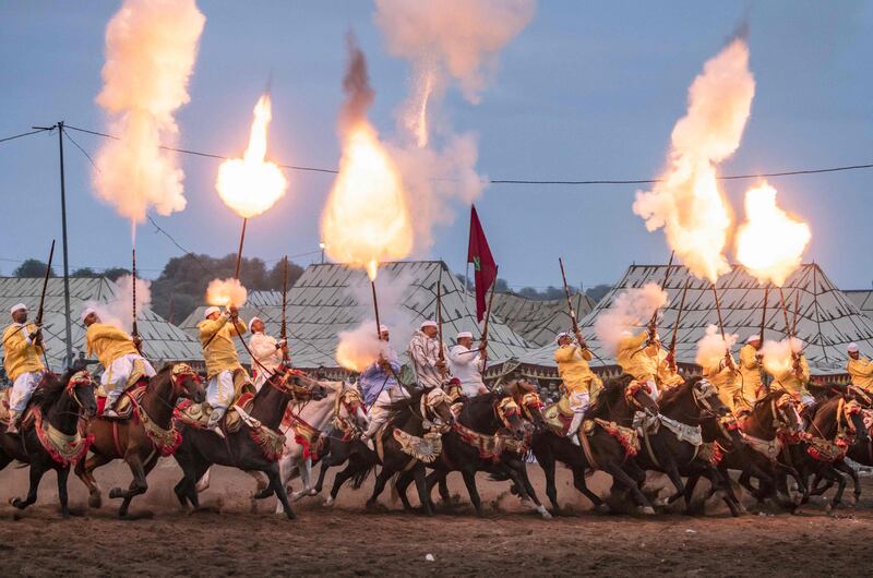 Riders add rifle fire to their horseback skills at the Moussem gathering in Rabat, Morocco's capital.