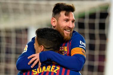 Barcelona's Argentinian forward Lionel Messi celebrates with Barcelona's Uruguayan forward Luis Suarez after scoring during the Spanish Copa del Rey (King's Cup) quarter-final second leg football match between Barcelona and Sevilla at the Camp Nou stadium in Barcelona on January 30, 2019. / AFP / LLUIS GENE