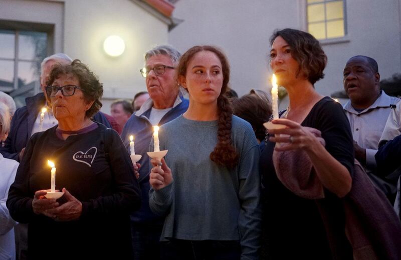 Mourners participate in a candle light vigil for the victims of the Chabad of Poway Synagogue shooting at the Rancho Bernardo Community Presbyterian Church on April 27, 2019. AFP