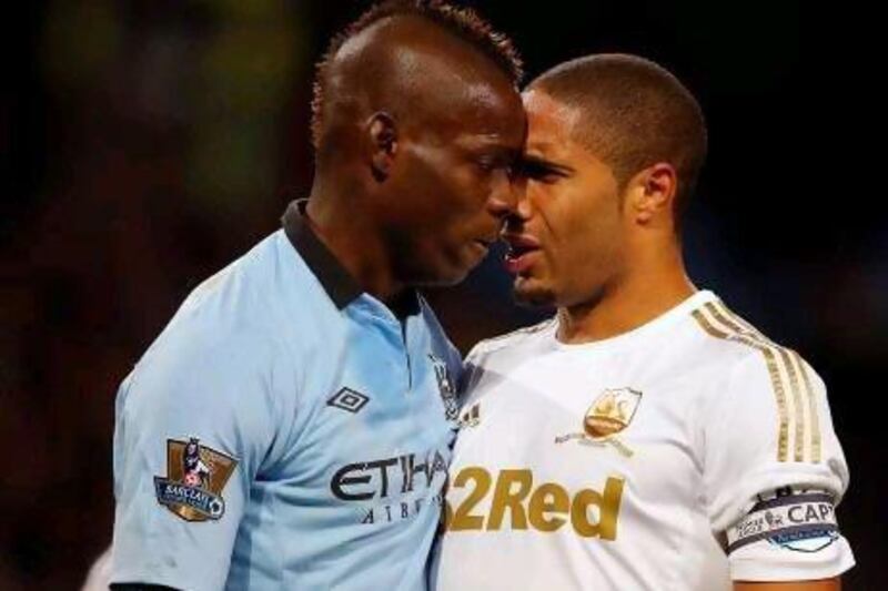 Mario Balotelli, left, came on at half time for Manchester City, and squared up to Swansea City captain Ashley Williams after the Italy striker felt he was pulled back in the area. Phil Noble / Reuters