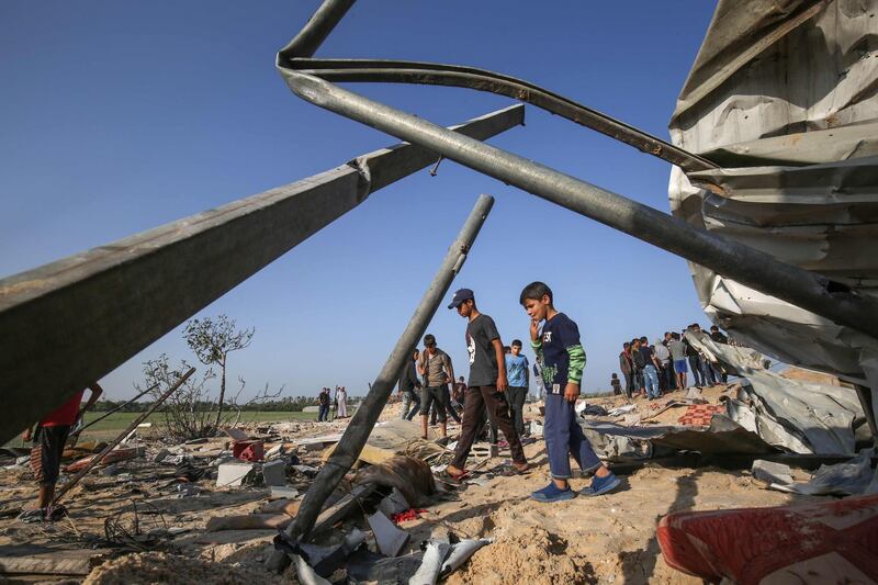 Palestinians gather at the site of an Israeli air strike in Deir Al Balah in the southern Gaza Strip. AFP
