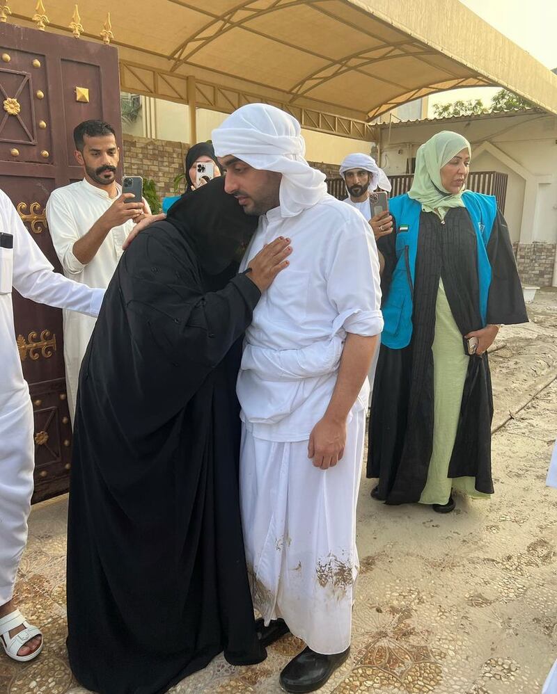 Sheikh Dr Rashid comforts a resident as Fujairah begins its recovery from the devastating effects of days of extreme weather.

