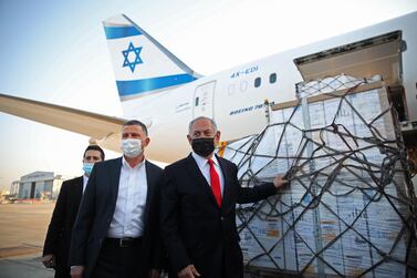 Israel's Prime Minister Benjamin Netanyahu and Health Minister Yuli Edelstein attend the arrival of a plane carrying a shipment of Pfizer-BioNTech anti-coronavirus vaccine at Ben Gurion airport. AFP