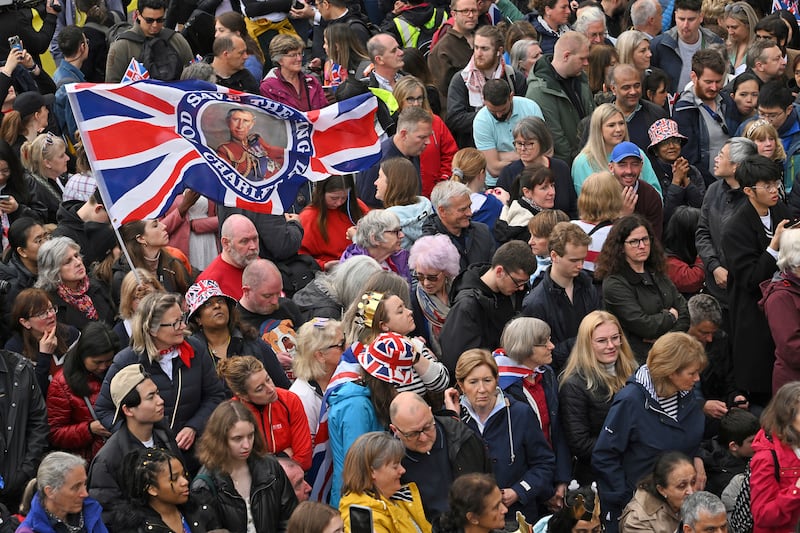 Well-wishers line the route of the coronation procession. AP