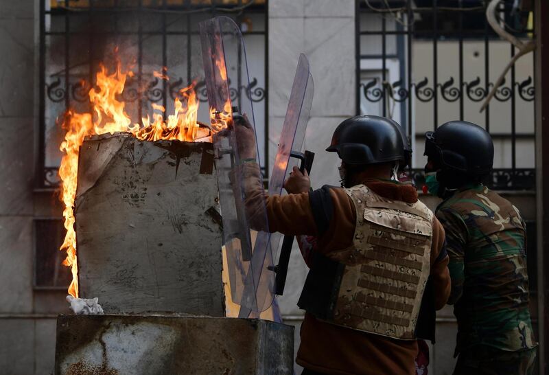 Iraqi anti-riot police forces clash with anti-government protesters at the Al Rasheed street in central Baghdad. EPA