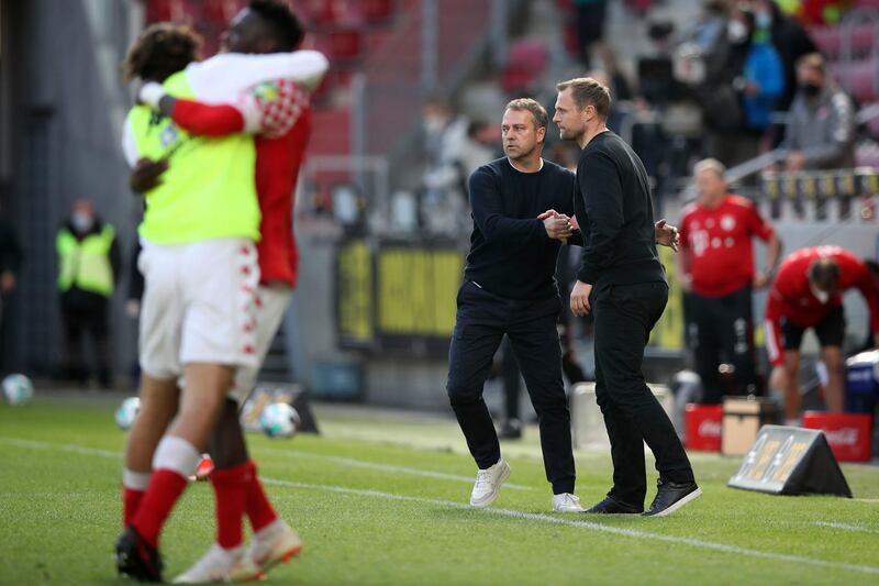 Bayern's head coach Hans-Dieter Flick, left, and Mainz's manager Bo Svensson shake hands after the match. AP