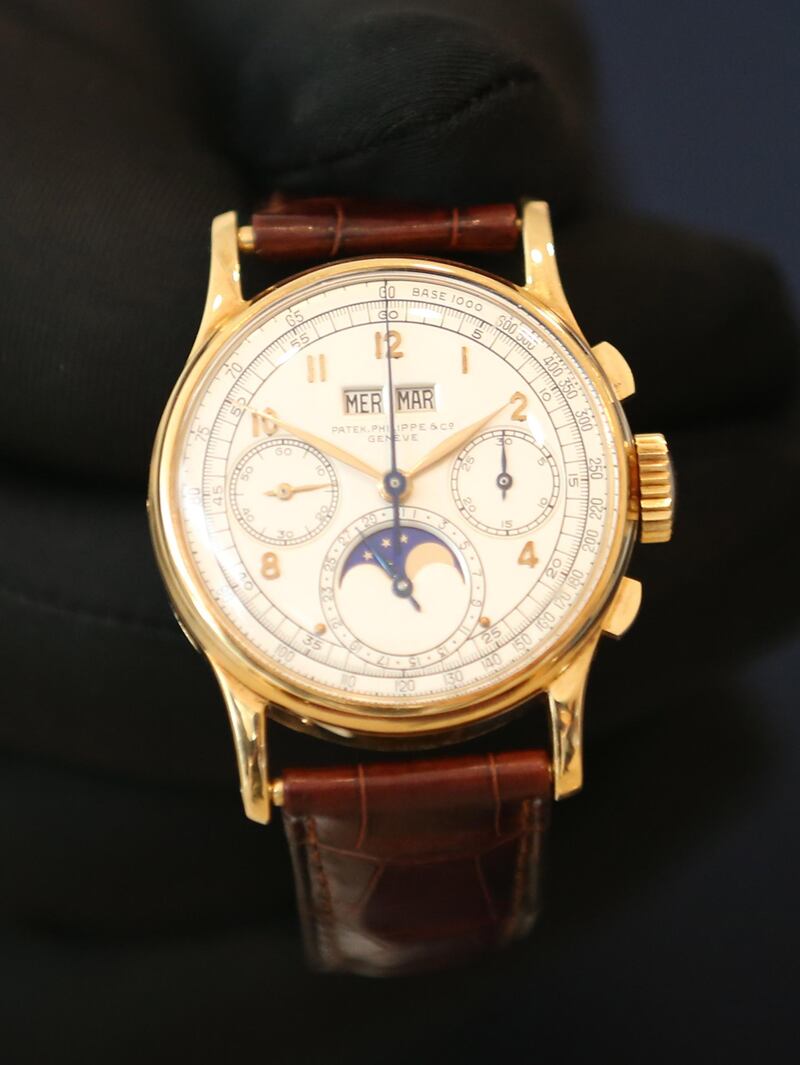 epa06614558 An exhibitor shows a watch by Patek Philippe for King Farouk of Egypt (1920 - 1965) during Christie's exhibition held at Jumairah Emirates Twin Towers in Gulf Emirate of Dubai, United Arab Emirates, 19 March 2018. Christie's auction will take place on 22 and 23 March 2018, presenting Modern and Contemporort Middle Eastern Arts and important watches.  EPA/ALI HAIDER