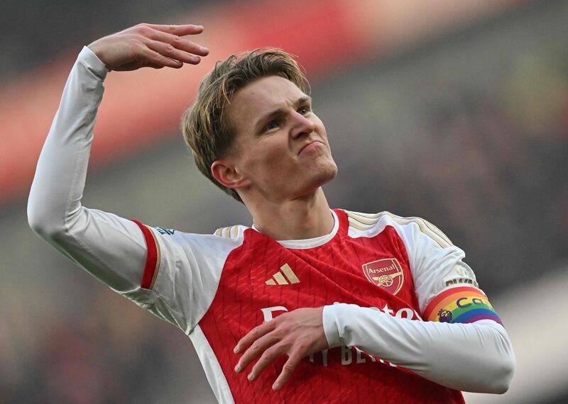 Arsenal's Norwegian midfielder #08 Martin Odegaard  celebrates scoring the team's second goal during the English Premier League football match between Arsenal and Wolverhampton Wanderers at the Emirates Stadium in London on December 2, 2023.  (Photo by Glyn KIRK / AFP) / RESTRICTED TO EDITORIAL USE.  No use with unauthorized audio, video, data, fixture lists, club/league logos or 'live' services.  Online in-match use limited to 120 images.  An additional 40 images may be used in extra time.  No video emulation.  Social media in-match use limited to 120 images.  An additional 40 images may be used in extra time.  No use in betting publications, games or single club/league/player publications.   /  