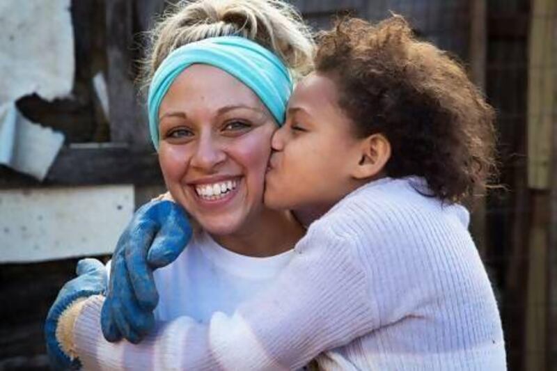 Geraldine Hafez, an Egyptian who studied at the American University of Sharjah, with one of the grateful favela children. Courtesy Amelia Johnson