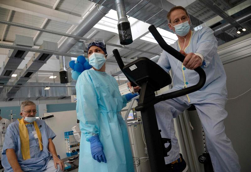 Covid-19 patients Jesus Nogales, left, and Juan Macero attend a physiotherapy session at the Isabel Zendal Hospital in Madrid, Spain. AFP