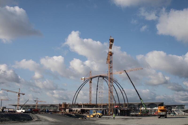 Airport employees are seen working on the mosque being built in front of the main terminal. Getty Images