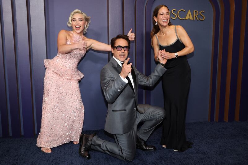 Robert Downey Jr pretends to renew his wedding vows with his wife Susan Downey as actress Florence Pugh, left, looks on, at the Governors Awards in Los Angeles. Reuters