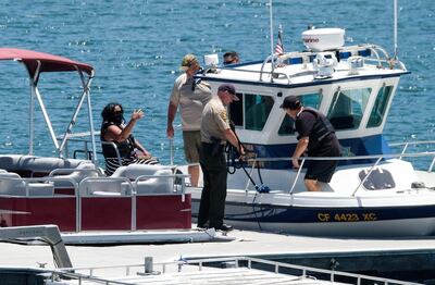 Naya Rivera's father, George Rivera, right, and mother Yolanda, left, with members of Ventura County Sheriff's Office are seen in a boat after Naya Rivera's body was found in Lake Piru, Monday, July 13, 2020, in Lake Piru, Calif. (AP Photo/Ringo H.W. Chiu)