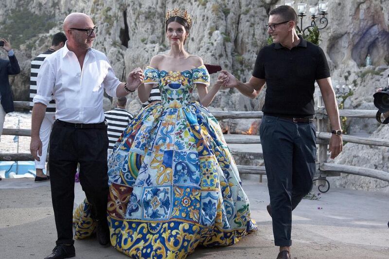 Domenico Dolce, left, and Stefano Gabbana, right, escort a model for the finale. Courtesy Matt Lever / James Cochcrane