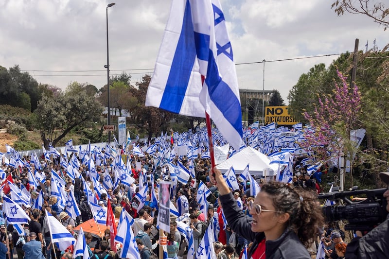 Israeli flags being waved outside the parliament in Jerusalem. Bloomberg