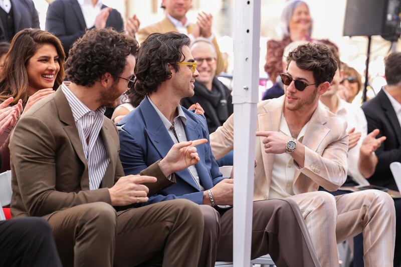 The Jonas Brothers and Priyanka Chopra during the star unveiling ceremony. Reuters