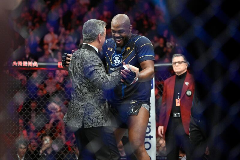 Jon Jones dances with announcer Bruce Buffer after defeating Ciryl Gane at UFC 285. AP