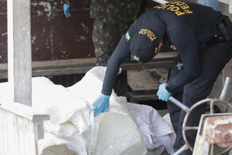 Brazilian Federal police officers examine a fishing boat during the search for British journalist Dom Phillips and indigenous expert Bruno Pereira, who both went missing in the Amazon rainforest more than a week ago. Reuters