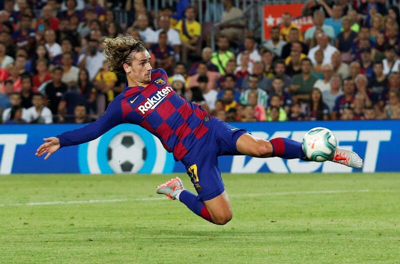 Barcelona's Antoine Griezmann stretches to equalise against Betis. Reuters