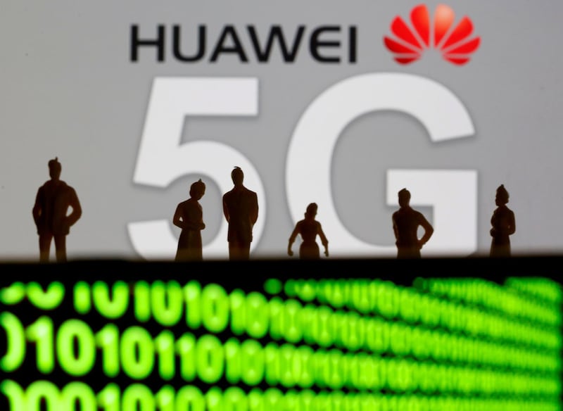 FILE PHOTO: Small toy figures are seen in front of a displayed Huawei and 5G network logo in this illustration picture, March 30, 2019. REUTERS/Dado Ruvic/Illustration/File Photo