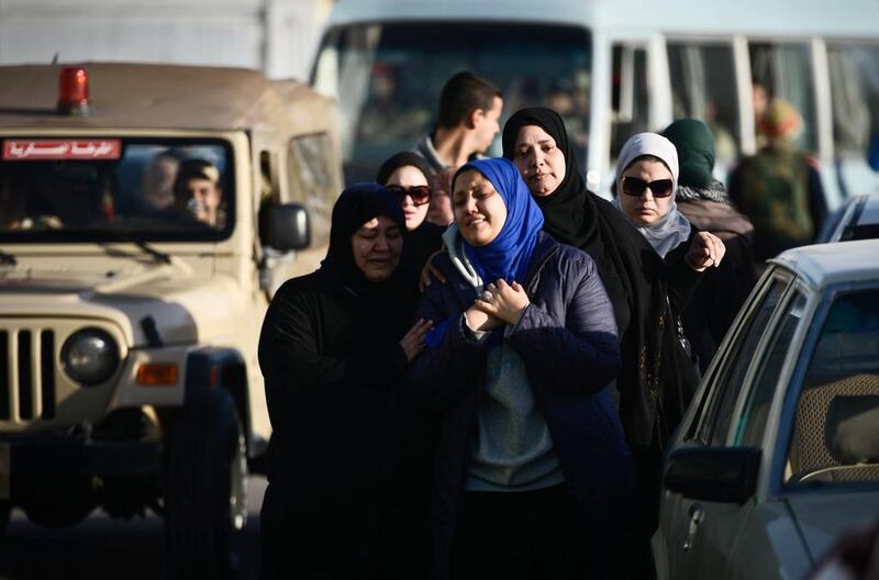 Egyptian relatives of security force members who were killed in North Sinai province during an attack the day before, arrive crying at Al Maza military airport where the bodies had been flown on January 30 in Cairo. AFP Photo

