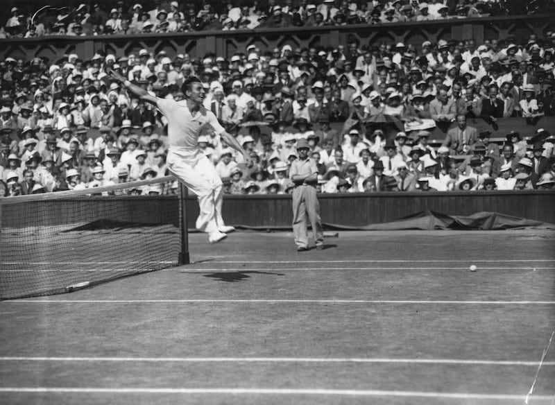Fred Perry, the Englishman who won the men's singles title three times during the sport's amateur era, leaps over the net after defeating Australia's Jack Crawford in the 1934 final.