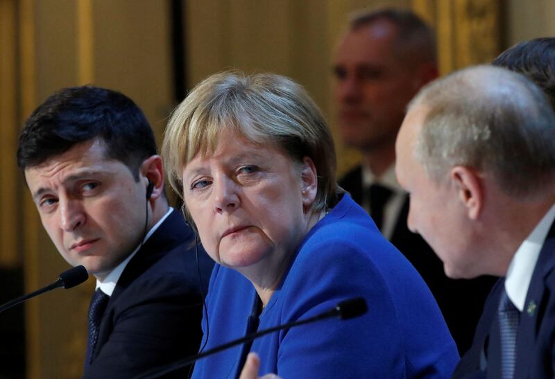 Ukrainian President Volodymyr Zelenskyy and then German chancellor Angela Merkel listen to Russian leader Vladimir Putin after a summit on Ukraine at the Elysee Palace, Paris, in December 2019. AFP
