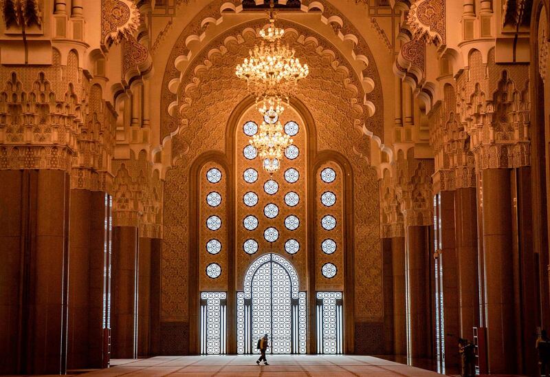 A worker clad in protective gear sterilises the interior of the Hasan II mosque in Casablanca. AFP