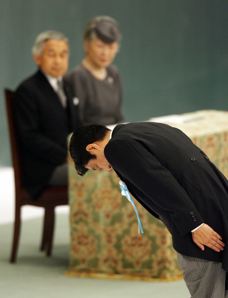 This file photo taken on August 15, 2007 shows Japanese Prime Minister Shinzo Abe (R) bowing at the alter as Emperor Akihito (L) and Empress Michiko (C) look on during a memorial ceremony for the national war dead to commemorate the end of World War II. AFP
