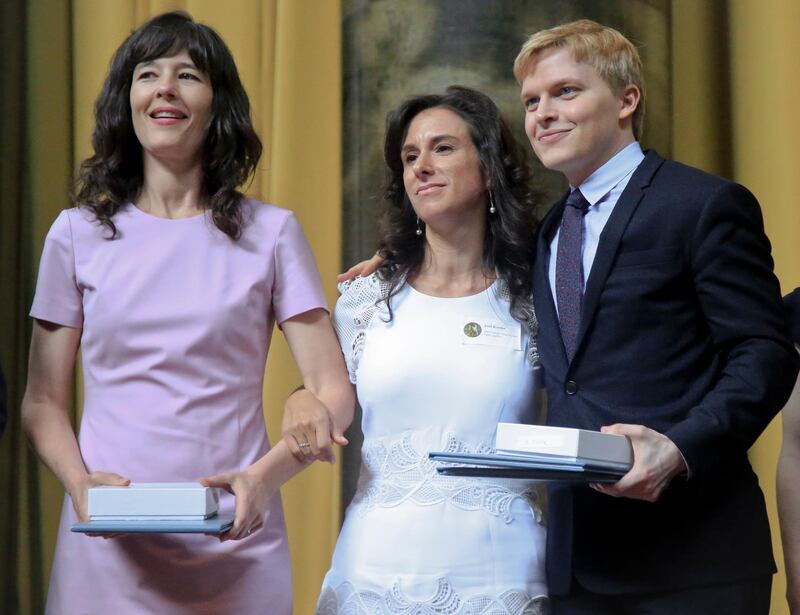 2018 Pulitzer Prize winners for public service journalism, Megan Twohey, left, Jodi Kantor, centre, and Ronan Farrow, right, pose after accepting their awards. AP