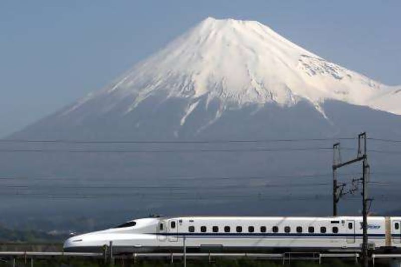 Central Japan Railway Co.'s N700 series Shinkansen bullet train travels past Mount Fuji, in Fuji City, Shizuoka Prefecture, Japan, on Friday, April 30, 2010. The Japanese government in April arranged for the state-owned Japan Bank for International Cooperation to lend money to U.S. projects to build high-speed links. Central Japan Railway, the operator of Japan's busiest bullet train line, has said that it is interested in bidding for projects in Florida and California. Photographer: Tomohiro Ohsumi/Bloomberg

