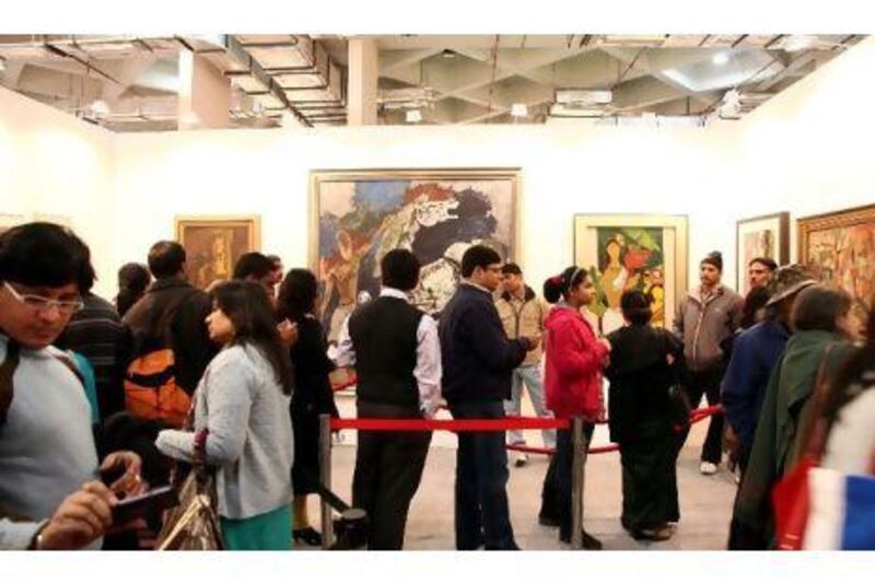 Art enthusiasts queue to view the works of M F Husain in a gallery in New Delhi over the weekend.