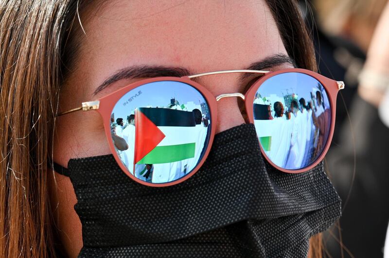The flag of Palestine is reflected in the sunglasses of a protester at Irada Square,  outside the National Assembly in Kuwait City, Kuwait. EPA