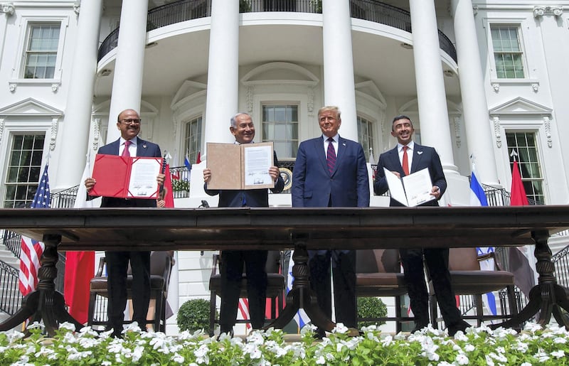 (L-R)Bahrain Foreign Minister Abdullatif al-Zayani, Israeli Prime Minister Benjamin Netanyahu, US President Donald Trump, and UAE Foreign Minister Abdullah bin Zayed Al-Nahyan hold up documents after participating in the signing of the Abraham Accords where the countries of Bahrain and the United Arab Emirates recognize Israel, at the White House in Washington, DC, September 15, 2020. - Israeli Prime Minister Benjamin Netanyahu and the foreign ministers of Bahrain and the United Arab Emirates arrived September 15, 2020 at the White House to sign historic accords normalizing ties between the Jewish and Arab states. (Photo by SAUL LOEB / AFP)