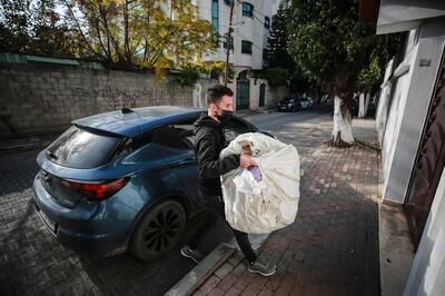 Majdi Al Rayass, 21, delivers goods that he received from a shipping company. Majd Mahmoud/The National