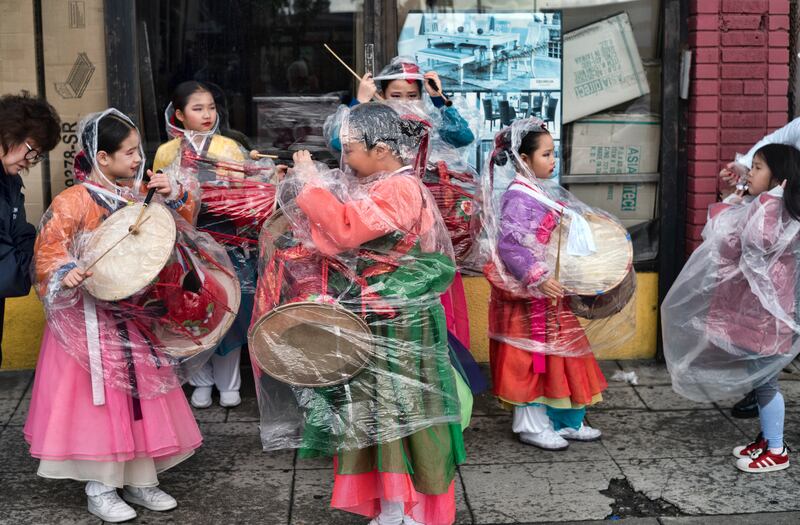 Kim Eung Hwa Korean Dance Academy pupils participate in the Kingdom Day Parade in Los Angeles, despite the bad weather. AP
