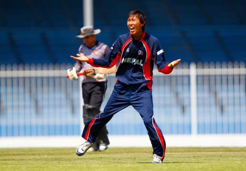 Shakti Prasad Gauchan of Nepal celebrates taking the wicket of Khurram Khan of the UAE, while Kurram Khan leaves the field behind him dejected during the ACC Trophy Final between the UAE and Nepal at Sharjah Cricket Stadium, Sharjah on the 12th October 2012.  Credit: Jake Badger/The National


