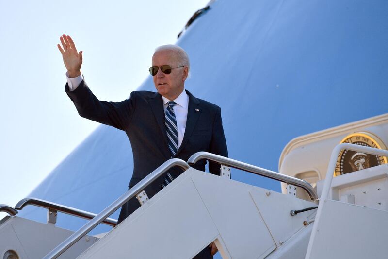 US President Joe Biden waves as he boards Air Force One before departing from Andrews Air Force Base in Maryland on May 19, 2021 en route to Rhode Island. / AFP / Nicholas Kamm
