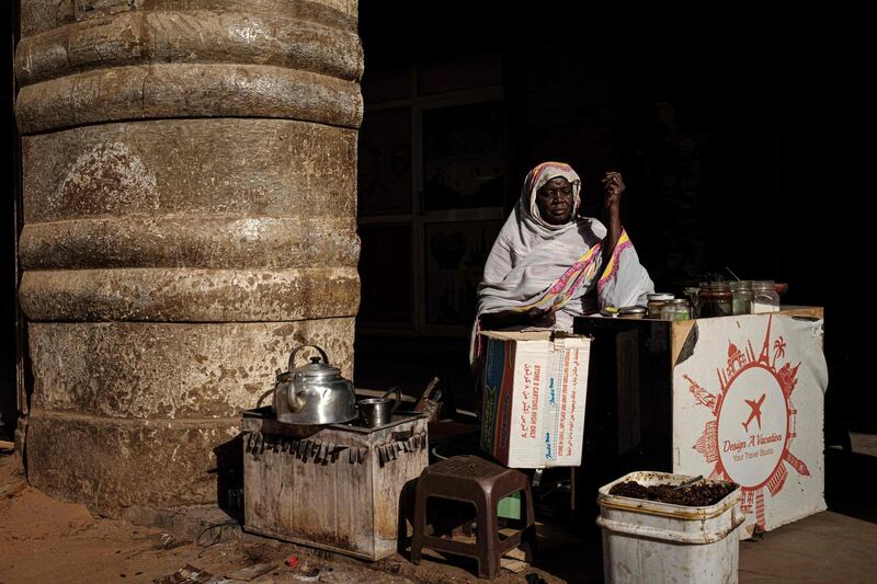 A Sudanese woman sells tea and coffee on a street in Khartoum. AFP