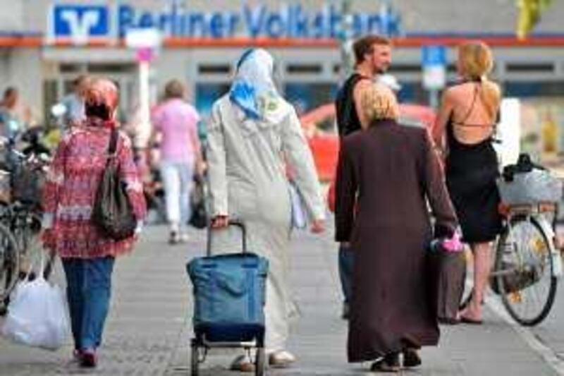 Three veiled women walk along a street in the Berlin district of Kreuzberg - Neukoelln on July 16, 2009. Around 120,000 Turks live currently in Berlin, which has a total population of 3.4 millions. AFP PHOTO KAVEH ROSTAMKHANI