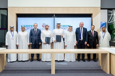 Rashed Al Blooshi, under-secretary of the Abu Dhabi Department of Economic Development (fourth from right), Arafat Al Yafei, executive director of the Industrial Development Bureau (centre), and Khalid bin Hadi, UAE managing director at Siemens Energy (fourth from left), during the signing ceremony. Photo: Abu Dhabi Department of Economic Development