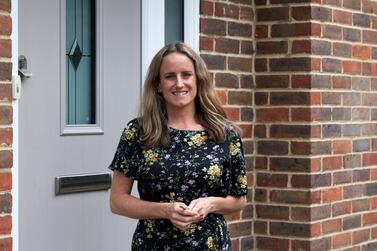 Alice on the doorstep of her new home on the West Sussex border, after an eight-month journey to buy a home in the UK. Martin Bamford for The National 