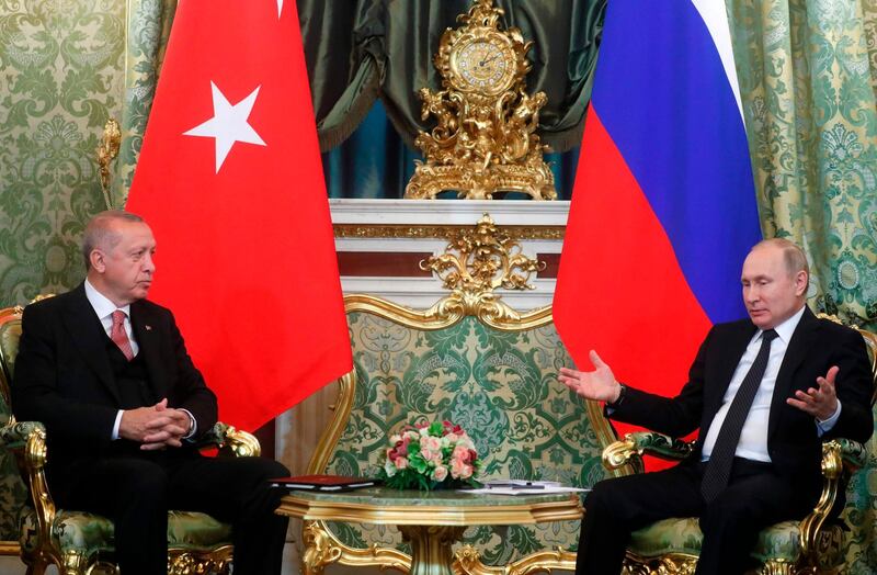 Russian President Vladimir Putin (R) speaks with Turkish President Recep Tayyip Erdogan during their meeting at The Kremlin in Moscow on April 8, 2019.  / AFP / POOL / Maxim SHIPENKOV
