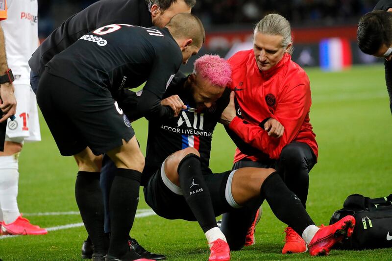 Neymar receives treatment from the club's medical staff. AP