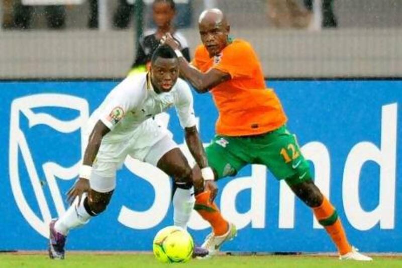 Ghana's Samuel Inkoom defends against Zambia's James Chamanga.