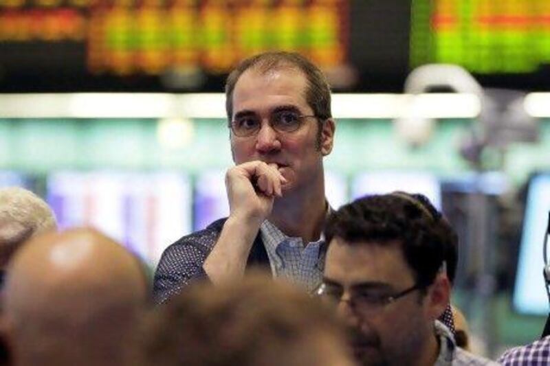 Traders work in the oil options pit at the New York Mercantile Exchange on Thursday, as oil lingered near seven-month lows around $90 a barrel as Europe's debt crisis festers and China's economy continues to slow. AP Photo