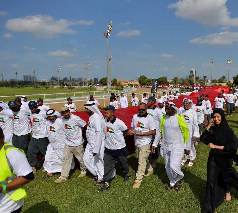 Most people carrying a flag banner: The UAE broke the world record of most people carrying a flag banner in 2015 with a participation of 2139 Emirati students from the Abu Dhabi Vocational Education and Training Institute (ADVETI), and incorporation with Abu Dhabi Equestrian Club. Marking the celebrations of the 43rd UAE National Day, thousands of Emirati students walked a span of 230 meters carrying the UAE flag, measuring two kilometres long and five meters wide, at the Abu Dhabi Equestrian Club. Courtesy Abu Dhabi Vocational Education and Training Institute

  