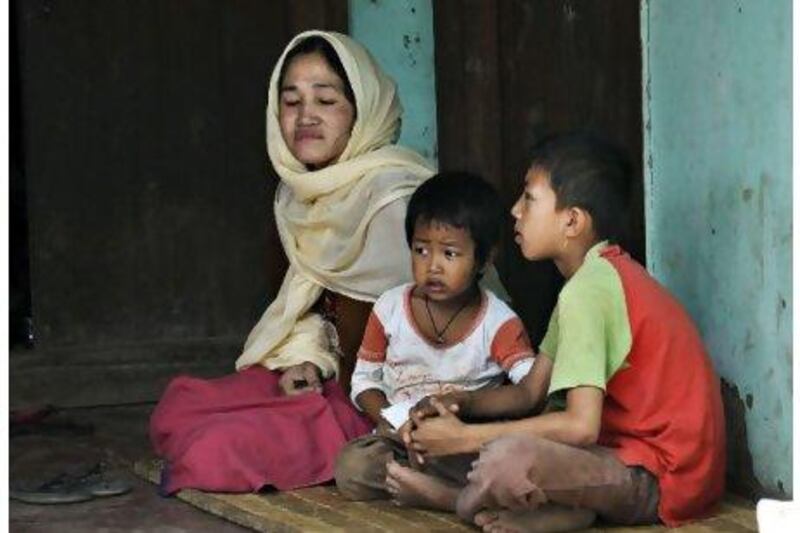 Kongkham Gangarani Devi with her children. Security forces killed her husband in March 2008.